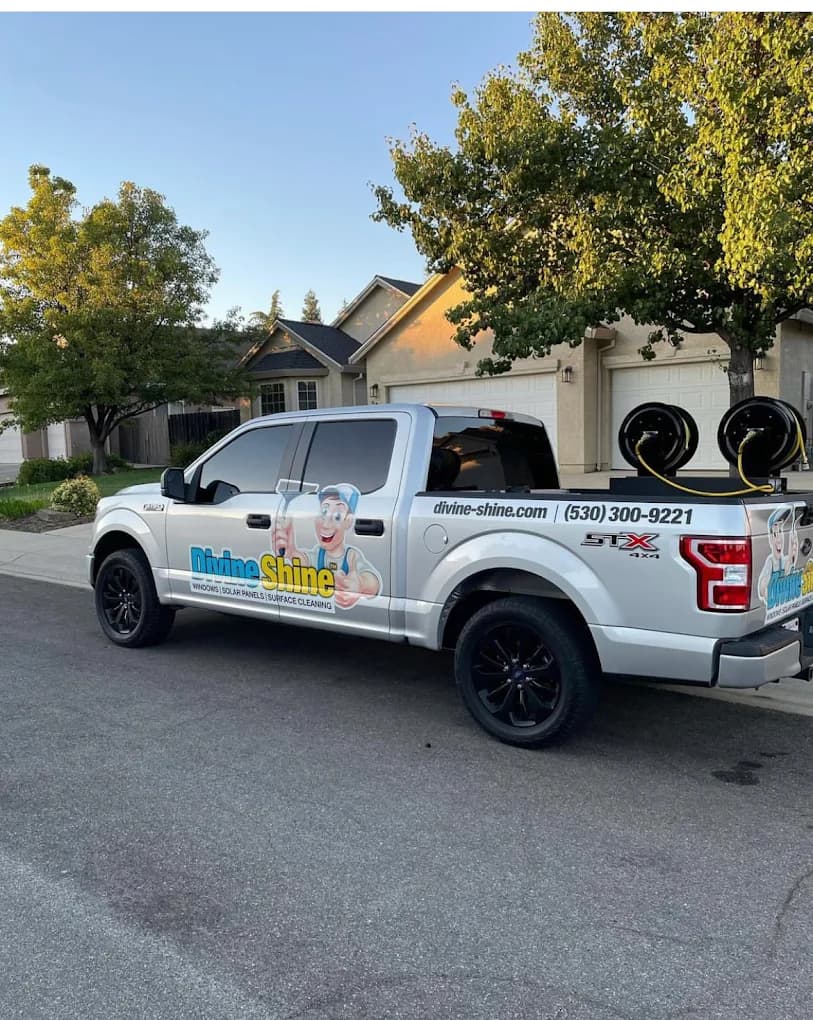 A branded Divine Shine truck parked in a customer's driveway, ready for a scheduled service